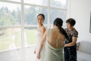 Bride getting into wedding dress