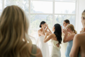 Emotional bride at first look with friends in Aspen