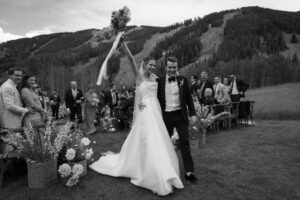 Bride and groom exit wedding ceremony at Beanos Cabin 