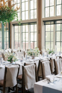 Reception tables with beautiful white and blue flowers at Beanos Cabin